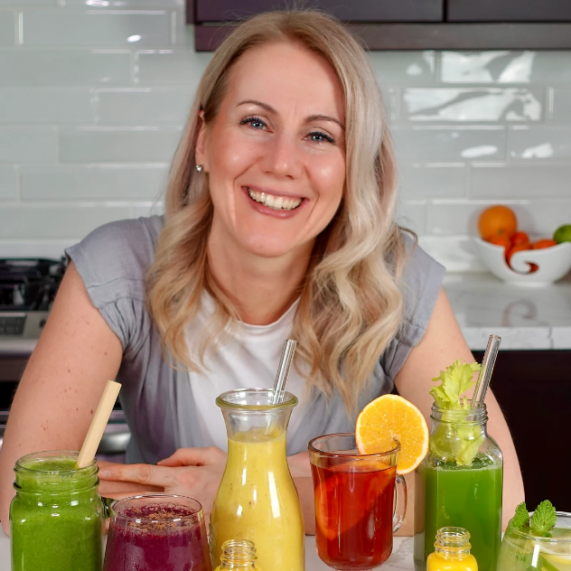Eva sitting in a kitchen with different types of juice in front of her